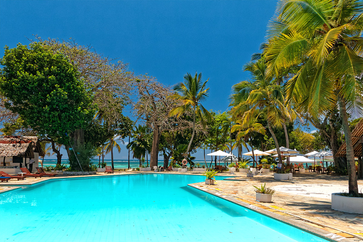 Swimming pool surrounded by palm trees at Safari Beach Hotel