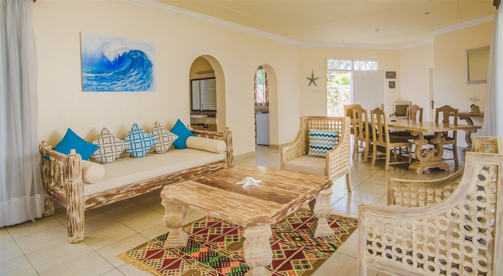 Villa lounge and dining area with Swahili-carved furniture at The Zubeida